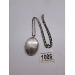 A good sized silver locket on silver chain.