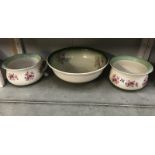 A pair of floral decorated Staffordshire chamber pots and a wash basin.