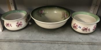 A pair of floral decorated Staffordshire chamber pots and a wash basin.