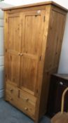 A solid pine wardrobe with 3 drawers.