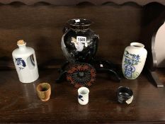 A Japanese vase, a Sake' bottle, 3 Sake' cups and an Oriental vase on cart stand.