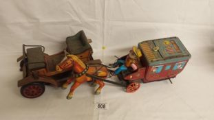 2 Japanese tin plate battery operated toys: a stagecoach with horse and cowboy (missing 1 wheel)