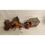 2 Japanese tin plate battery operated toys: a stagecoach with horse and cowboy (missing 1 wheel)