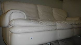 A 3 seat cream leather sofa.
