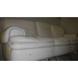 A 3 seat cream leather sofa.