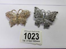 2 jewelled butterfly brooches.