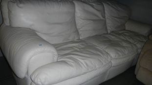A 3 seat cream leather sofa.
