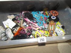 A large box of costume jewellery.