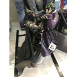 An Arkham Origins video game collectors edition figurine of Batman and Joker.