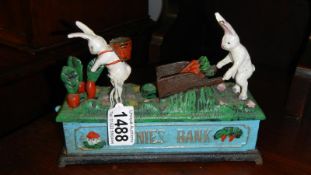 A cast iron bunnies mechanical money bank.
