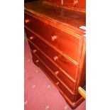 A 4 drawer stained pine chest.