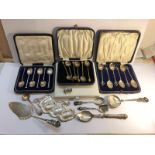 4 cased sets of various cutlery, loose cutlery and 4 silver plate drinks labels.