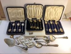 4 cased sets of various cutlery, loose cutlery and 4 silver plate drinks labels.