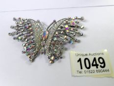 A Butler and Wilson butterfly brooch.