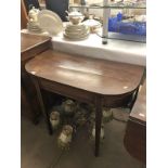 A mahogany fold over card table.