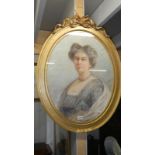 An oval framed portrait of a lady.