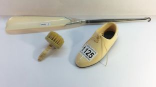 A bone shoe, a bone brush and a bone shoe horn button hook with bone horn and silver mount,