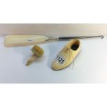 A bone shoe, a bone brush and a bone shoe horn button hook with bone horn and silver mount,