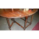 An oak barley twist gate leg table.