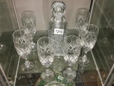 A cut glass decanter and 6 glasses.