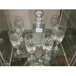 A cut glass decanter and 6 glasses.