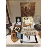 A mixed lot of military items including coats of arms, pictures, books etc.