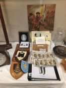 A mixed lot of military items including coats of arms, pictures, books etc.