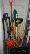 A garden strimmer and garden tools.