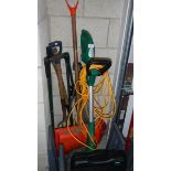 A garden strimmer and garden tools.