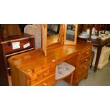 A pine dressing table, mirror and stool.