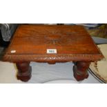 A carved mahogany foot stool.