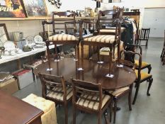 An oval dining table and 6 chairs.