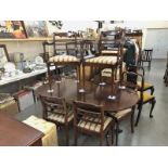 An oval dining table and 6 chairs.