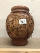 A carved wood vase.