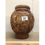 A carved wood vase.