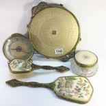 A dressing table tray, clock, brush, mirror and powder bowl.