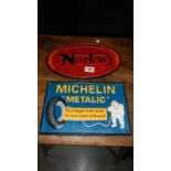 A cast iron Norton sign and a cast iron Michelin sign.