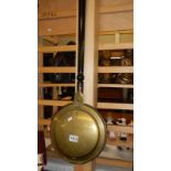 A brass warming pan.