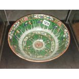An oriental hand painted green bowl.