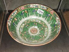 An oriental hand painted green bowl.