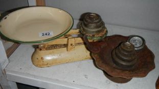 A set of scales with weights and a bird feeder.