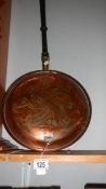A copper warming pan.