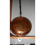 A copper warming pan.