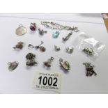 14 silver charms, a St. Christopher pendant and a bracelet.