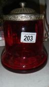 A cranberry glass biscuit barrel.