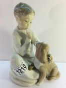 A Lladro boy with dog.