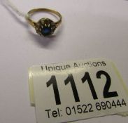 A gold ring set with diamonds and sapphire (no hall mark but tests as 18ct). Size N.