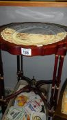 A mahogany table with ceramic top.