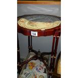 A mahogany table with ceramic top.