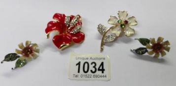 A pair of enameled floral earrings and 2 enameled floral brooches.